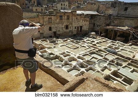 Man photographing dilapidated ancient ruins in cityscape, Medina, Fes, Morocco View Large Photo Image Stock Photo - Man photographing dilapidated ancient ruins in cityscape, Medina, Fes, Morocco. Fotosearch