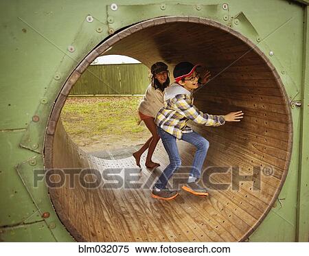 Mixed race children playing in wheel in playground View Large Photo Image Stock Photography - Mixed race children playing in wheel in playground. Fotosearch