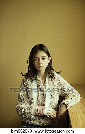 Stock Photo - Mixed race girl wearing sling on arm. Fotosearch