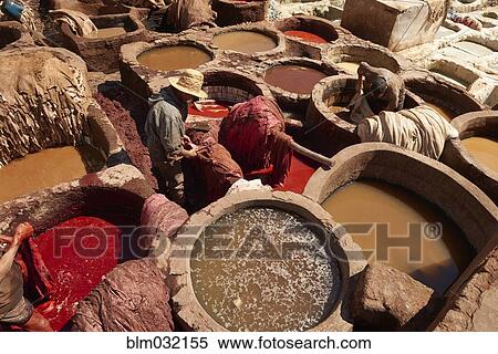 People working with tanks of dye and solvents in tannery, Medina, Fes, Morocco View Large Photo Image Stock Photography - People working with tanks of dye and solvents in tannery, Medina, Fes, Morocco. Fotosearch