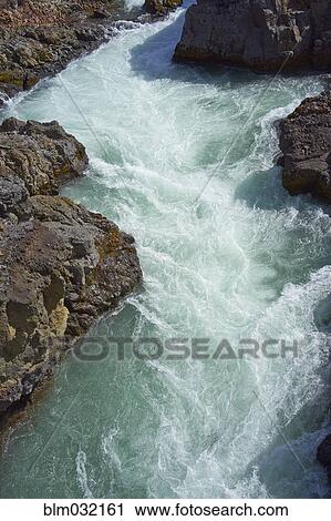 Stock Image - River rushing through rock formations. Fotosearch