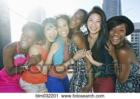 Women hugging on urban rooftop View Large Photo Image Stock Image - Women hugging on urban rooftop. Fotosearch
