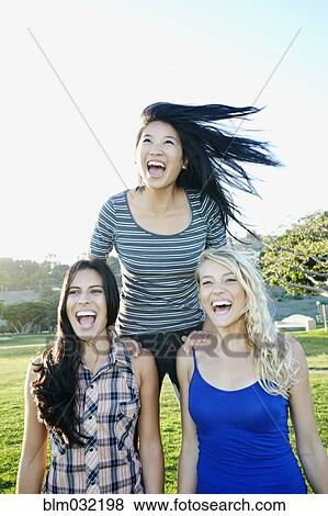 Women playing in field outdoors View Large Photo Image Stock Photo - Women playing in field outdoors. Fotosearch