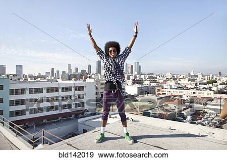 African American man and cityscape from urban rooftop View Large Photo Image Stock Photo - African American man and cityscape from urban rooftop. Fotosearch