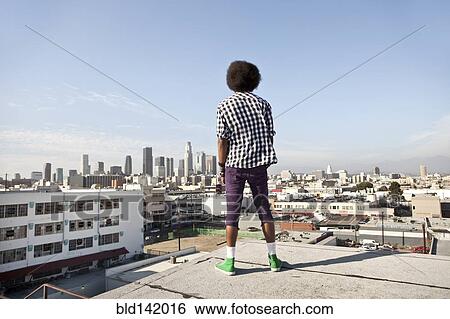 African American man overlooking cityscape from urban rooftop View Large Photo Image Stock Photograph - African American man overlooking cityscape from urban rooftop. Fotosearch