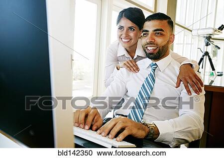 Business people working at computer in office View Large Photo Image Stock Image - Business people working at computer in office. Fotosearch