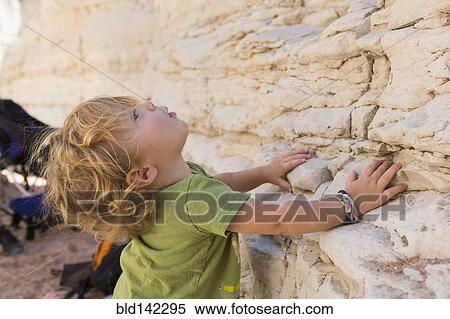 Stock Photography - Caucasian baby boy exploring rock formations. Fotosearch