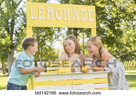 Stock Photograph - Caucasian children talking at lemonade stand. Fotosearch