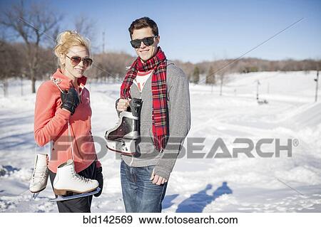 Caucasian couple carrying ice skates in winter View Large Photo Image Stock Photo - Caucasian couple carrying ice skates in winter. Fotosearch