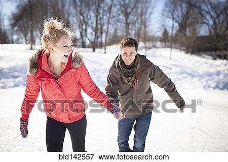 Caucasian couple ice skating on frozen lake View Large Photo Image Stock Photo - Caucasian couple ice skating on frozen lake. Fotosearch
