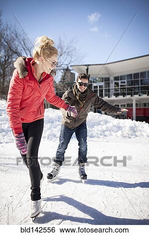 Caucasian couple ice skating on frozen lake View Large Photo Image Stock Photograph - Caucasian couple ice skating on frozen lake. Fotosearch