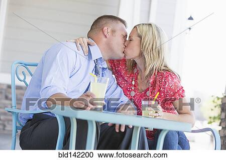 Caucasian couple kissing on porch View Large Photo Image Stock Image - Caucasian couple kissing on porch. Fotosearch