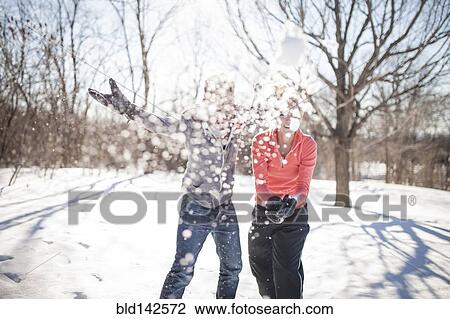 Caucasian couple throwing snowballs View Large Photo Image Stock Image - Caucasian couple throwing snowballs. Fotosearch