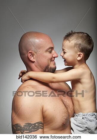 Stock Photograph - Caucasian father holding son. Fotosearch