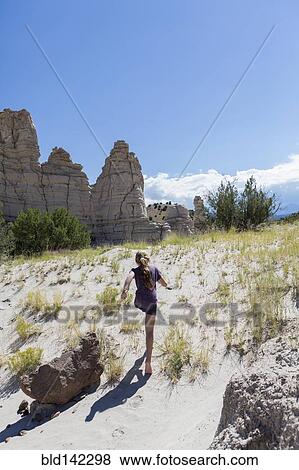 Stock Photo - Caucasian girl exploring rock formations, Abiquiu, New Mexico, United States. Fotosearch