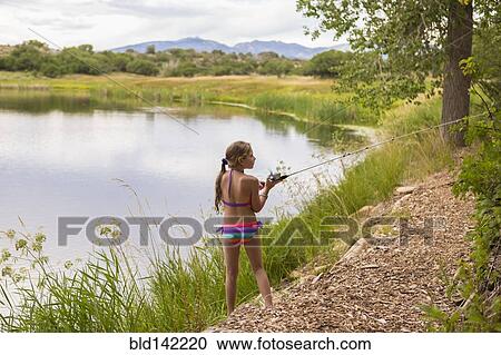 Caucasian girl fishing in rural lake View Large Photo Image Stock Image - Caucasian girl fishing in rural lake. Fotosearch