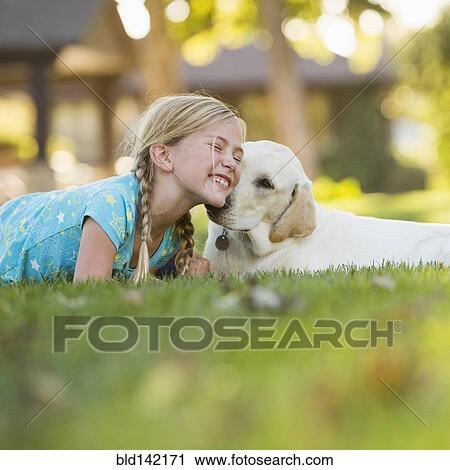 Caucasian girl nuzzling pet dog on grassy lawn View Large Photo Image Stock Image - Caucasian girl nuzzling pet dog on grassy lawn. Fotosearch
