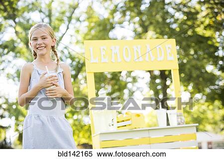 Stock Photography - Caucasian girl smiling at lemonade stand. Fotosearch