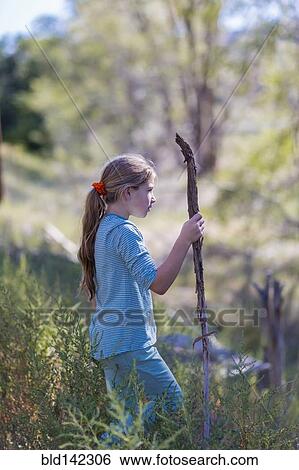 Caucasian girl walking in rural grassy field View Large Photo Image Stock Photograph - Caucasian girl walking in rural grassy field. Fotosearch