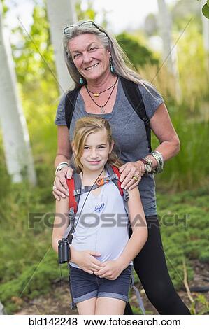 Caucasian grandmother and granddaughter smiling in forest View Large Photo Image Stock Photo - Caucasian grandmother and granddaughter smiling in forest. Fotosearch