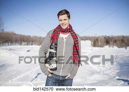 Caucasian man carrying ice skates in snow View Large Photo Image Stock Image - Caucasian man carrying ice skates in snow. Fotosearch