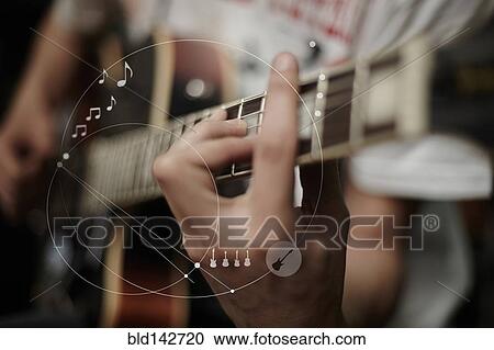Stock Image - Caucasian man playing guitar overlaid with graphic design. Fotosearch