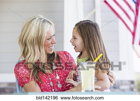 Caucasian mother and daughter laughing on porch View Large Photo Image Stock Photograph - Caucasian mother and daughter laughing on porch. Fotosearch