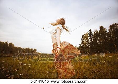 Caucasian woman dancing in field View Large Photo Image Stock Photography - Caucasian woman dancing in field. Fotosearch