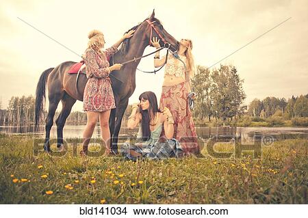 Caucasian women petting horse in rural field View Large Photo Image Picture - Caucasian women petting horse in rural field. Fotosearch