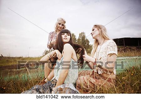 Caucasian women relaxing in field View Large Photo Image Stock Image - Caucasian women relaxing in field. Fotosearch