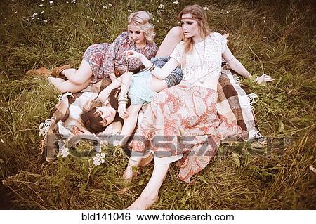Caucasian women relaxing in field View Large Photo Image Stock Photograph - Caucasian women relaxing in field. Fotosearch