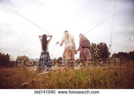Stock Image - Caucasian women standing in field. Fotosearch