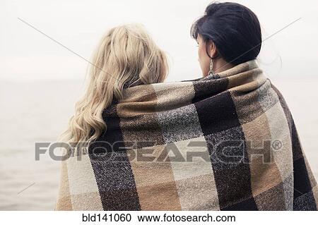 Caucasian women wrapped in blanket outdoors View Large Photo Image Stock Image - Caucasian women wrapped in blanket outdoors. Fotosearch