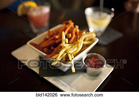 Stock Photograph - Close up of bowl of french fries in restaurant. Fotosearch