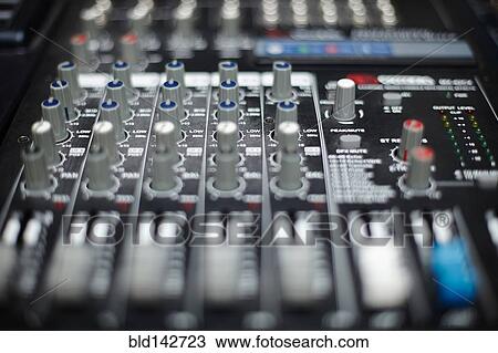 Stock Image - Close up of knobs on control panel. Fotosearch