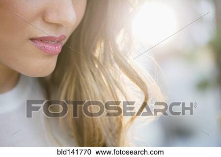 Stock Image - Close up of lips and hair of Hispanic woman. Fotosearch