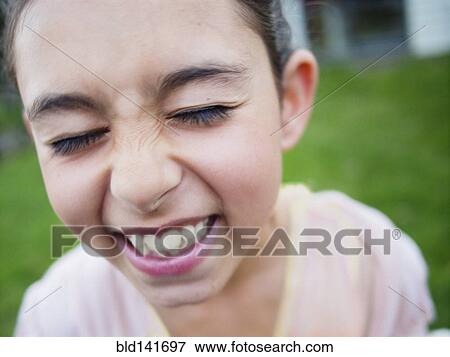 Stock Photo - Close up of mixed race girl laughing. Fotosearch