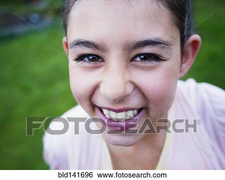 Stock Photograph - Close up of mixed race girl laughing. Fotosearch