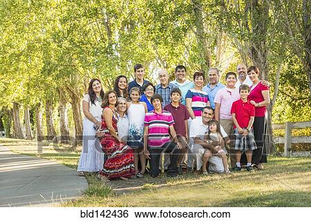 Stock Photograph - Extended family posing together outdoors. Fotosearch