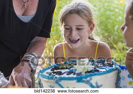 Family celebrating birthday together outdoors View Large Photo Image Stock Photo - Family celebrating birthday together outdoors. Fotosearch