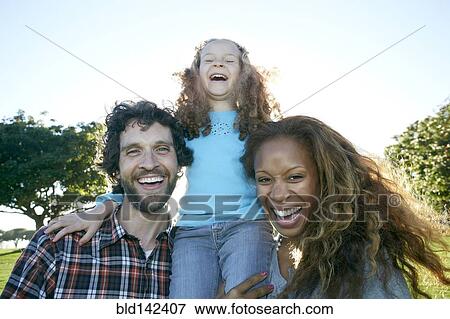Family laughing together outdoors View Large Photo Image Stock Photo - Family laughing together outdoors. Fotosearch