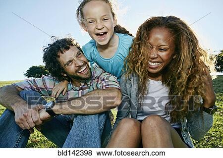 Stock Photo - Family playing together outdoors. Fotosearch