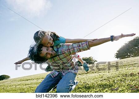 Stock Photograph - Father and daughter playing outdoors. Fotosearch