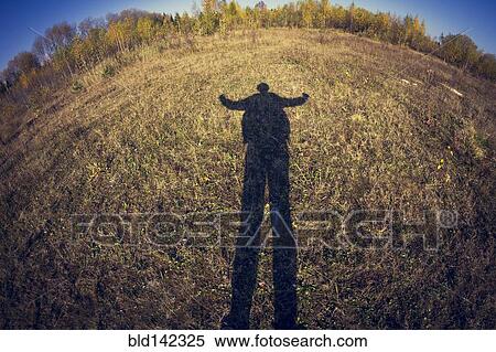 Fish-eye lens view of shadow of man in field View Large Photo Image Stock Photography - Fish-eye lens view of shadow of man in field. Fotosearch