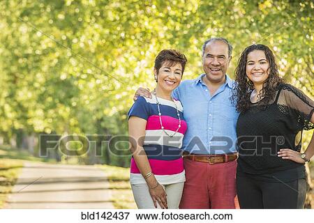 Stock Photo - Hispanic family smiling together outdoors. Fotosearch