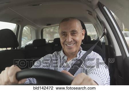 Stock Image - Hispanic senior man driving car. Fotosearch