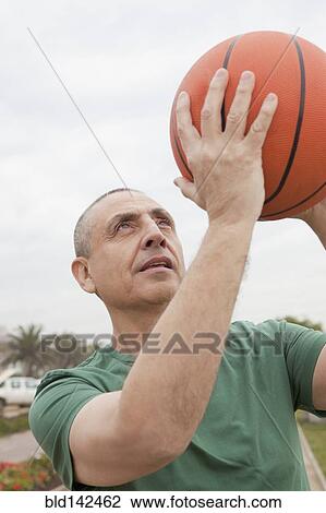 Hispanic senior man playing basketball outdoors View Large Photo Image Stock Image - Hispanic senior man playing basketball outdoors. Fotosearch