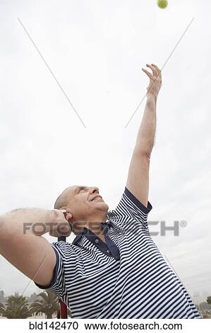 Hispanic senior man playing tennis outdoors View Large Photo Image Stock Image - Hispanic senior man playing tennis outdoors. Fotosearch