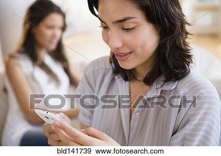 Hispanic woman using cell phone View Large Photo Image Stock Photo - Hispanic woman using cell phone. Fotosearch
