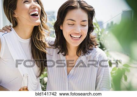 Hispanic women laughing outdoors View Large Photo Image Stock Image - Hispanic women laughing outdoors. Fotosearch